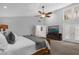 Main bedroom featuring a ceiling fan, a TV, and access to an attached bathroom at 2991 Timpana Pt, Longwood, FL 32779