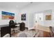 Bright office space featuring hardwood floors, modern black desk, and neutral-toned accent chair at 2991 Timpana Pt, Longwood, FL 32779