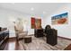 Modern home office with hardwood floors, ample natural light, and unique art at 2991 Timpana Pt, Longwood, FL 32779