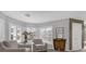 Cozy sitting room with plantation shutters, neutral decor, and a view of the pool at 2991 Timpana Pt, Longwood, FL 32779