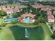Aerial view of community with pool, clubhouse, tennis court, and scenic lake with fountain at 3345 Messina Dr, Lake Mary, FL 32746