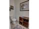 Powder room with an interesting license plate cabinet, decorative mirror, and white fixtures at 3345 Messina Dr, Lake Mary, FL 32746