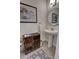 Charming powder room with unique cabinet made from license plates and decorative mirror and fixtures at 3345 Messina Dr, Lake Mary, FL 32746