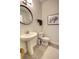 Small bathroom with pedestal sink, toilet, and neutral finishes at 3345 Messina Dr, Lake Mary, FL 32746