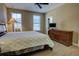 Comfortable bedroom with neutral carpet, ceiling fan, and ample natural light from two windows at 3345 Messina Dr, Lake Mary, FL 32746