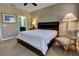 Bedroom with neutral carpet, ceiling fan, and a partial view of the bathroom at 3345 Messina Dr, Lake Mary, FL 32746