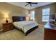 Bedroom featuring neutral carpeting, ceiling fan, two windows, and a classic, dark-wood bedroom set at 3345 Messina Dr, Lake Mary, FL 32746