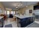 Island kitchen open floor plan featuring stainless appliances, large island and view of the living and dining areas at 3345 Messina Dr, Lake Mary, FL 32746
