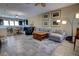 Open-concept living room and kitchen featuring tile flooring, a large sectional, and kitchen island with seating at 3345 Messina Dr, Lake Mary, FL 32746