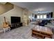 Open-concept living room and kitchen featuring tile flooring, a large sectional, and kitchen island with seating at 3345 Messina Dr, Lake Mary, FL 32746