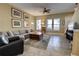 Cozy living room featuring a large sectional, hardwood coffee table, and tile flooring at 3345 Messina Dr, Lake Mary, FL 32746