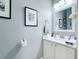 Cozy bathroom with gray paint, white vanity, and framed art at 4103 Calabria Ave, Davenport, FL 33897