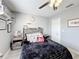 Cozy bedroom with a ceiling fan, stylish decor and plush bedding creates a comfortable, inviting space at 4103 Calabria Ave, Davenport, FL 33897