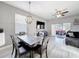 Open dining room with modern light fixture, seating, and access to the back patio at 4103 Calabria Ave, Davenport, FL 33897
