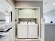 Convenient laundry area with white washer and dryer, built-in cabinets and close to the main bedroom at 4103 Calabria Ave, Davenport, FL 33897