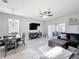 Open living room featuring modern light fixture, seating, and access to the back patio at 4103 Calabria Ave, Davenport, FL 33897
