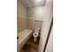 Compact bathroom featuring bathtub with tiled wall at 4215 S Semoran Blvd # 2, Orlando, FL 32822