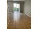 Living room featuring tile floors and a sliding glass door leading to the outside at 4215 S Semoran Blvd # 2, Orlando, FL 32822