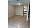 Open living room with tile floors and a view into the kitchen at 4215 S Semoran Blvd # 2, Orlando, FL 32822