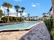 Relaxing community pool with ample seating, perfect for unwinding on sunny days in a tropical landscape at 4215 S Semoran Blvd # 2, Orlando, FL 32822