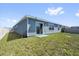 Backyard featuring a manicured lawn and blue siding at 429 N Andrea Cir, Haines City, FL 33844