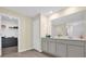 Bathroom featuring double sinks, quartz countertops, and a large mirror at 429 N Andrea Cir, Haines City, FL 33844