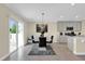 Contemporary dining area filled with natural light, with a modern table set and access to the backyard at 429 N Andrea Cir, Haines City, FL 33844