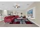Spacious living room featuring a modern entertainment center and a comfortable red sectional couch at 429 N Andrea Cir, Haines City, FL 33844