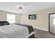Bright main bedroom with large window, ceiling fan, and a wall-mounted TV at 429 N Andrea Cir, Haines City, FL 33844