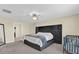 Comfortable main bedroom featuring neutral walls, ceiling fan, and large velvet headboard at 429 N Andrea Cir, Haines City, FL 33844