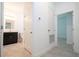 Hallway view of bathroom with double sink vanity, and doorway to another room at 4741 Sw 128Th St, Ocala, FL 34473