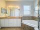 Bathroom with double sinks, bathtub, and a separate glass-door shower at 4919 Culdesac Ct, St Cloud, FL 34772