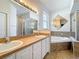 Bathroom featuring double sinks, a bathtub, and a glass-door shower at 4919 Culdesac Ct, St Cloud, FL 34772