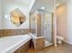 Bathroom boasting glass shower, bathtub, decorative diamond-shaped mirror at 4919 Culdesac Ct, St Cloud, FL 34772