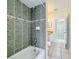 Well-lit bathroom with modern gray tiling and bath-shower combo for a relaxing home experience at 4919 Culdesac Ct, St Cloud, FL 34772