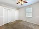 A carpeted bedroom with two closets and a window for natural light at 4919 Culdesac Ct, St Cloud, FL 34772