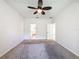 A carpeted bedroom has a ceiling fan and a glimpse into the bathroom at 4919 Culdesac Ct, St Cloud, FL 34772