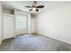 A carpeted bedroom features a ceiling fan and a window for natural light at 4919 Culdesac Ct, St Cloud, FL 34772