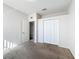 A carpeted bedroom with a closet and a doorway to another room at 4919 Culdesac Ct, St Cloud, FL 34772