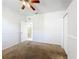 A carpeted bedroom with a ceiling fan and a doorway to another room at 4919 Culdesac Ct, St Cloud, FL 34772