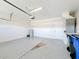 Well lit garage with painted floor, storage cabinet, and access door to the house or exterior at 4919 Culdesac Ct, St Cloud, FL 34772