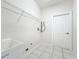 Bright laundry room with a utility sink, door to outside, and an overhead drying rack at 4919 Culdesac Ct, St Cloud, FL 34772
