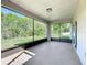 This enclosed patio with a concrete floor provides scenic views of the green backyard at 4919 Culdesac Ct, St Cloud, FL 34772