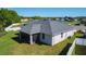 The home's rear exterior features a screened in lanai, and a well maintained lawn with an adjacent lake view at 4919 Culdesac Ct, St Cloud, FL 34772