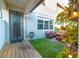 Cozy patio space with modern outdoor furniture set on artificial turf, string lights, and easy access to the back door at 5156 Caspian St, St Cloud, FL 34771