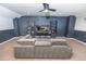 Finished basement with a large sectional sofa, a TV, and display shelves provides a comfortable space at 5156 Caspian St, St Cloud, FL 34771