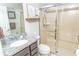 Modern bathroom with granite countertop, glass-enclosed shower, and stylish fixtures at 5156 Caspian St, St Cloud, FL 34771