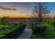 Scenic boardwalk surrounded by lush landscaping, leading to a tranquil vista at sunset at 5156 Caspian St, St Cloud, FL 34771