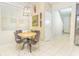 Cozy dining area features a wooden table, four chairs, and natural light from a window at 5156 Caspian St, St Cloud, FL 34771
