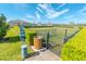 A fenced in community dog park and waste station in a well-manicured lawn at 5156 Caspian St, St Cloud, FL 34771
